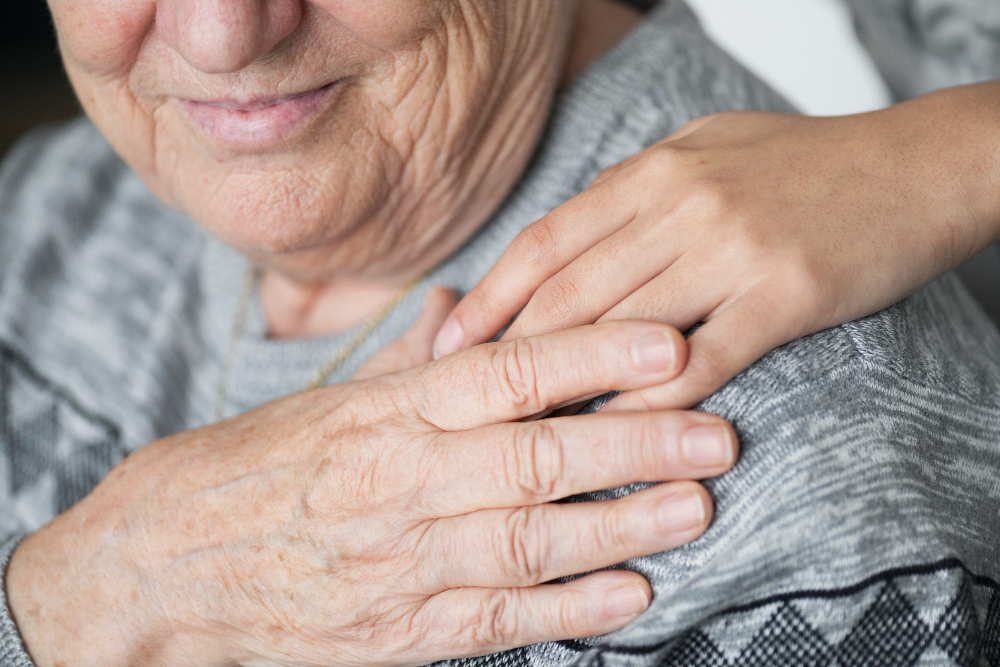 elderly people holding hands